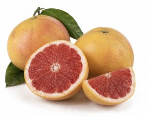 Star Ruby grapefruits, whole, halved and a wedge, on white